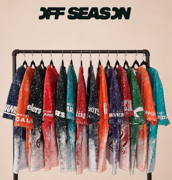 A rack of graphic tees, supporting a variety of NFL teams