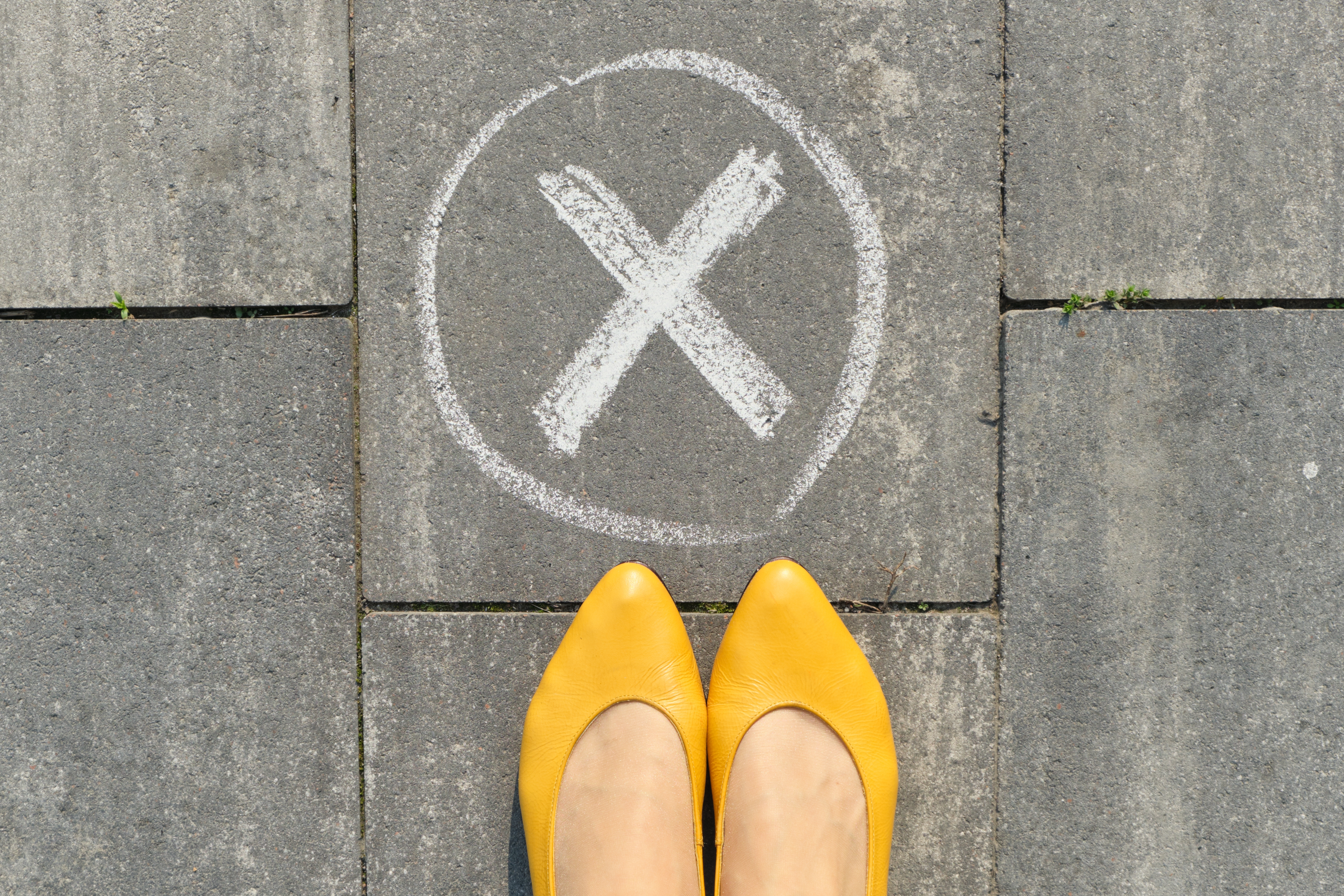 X sign on sidewalk