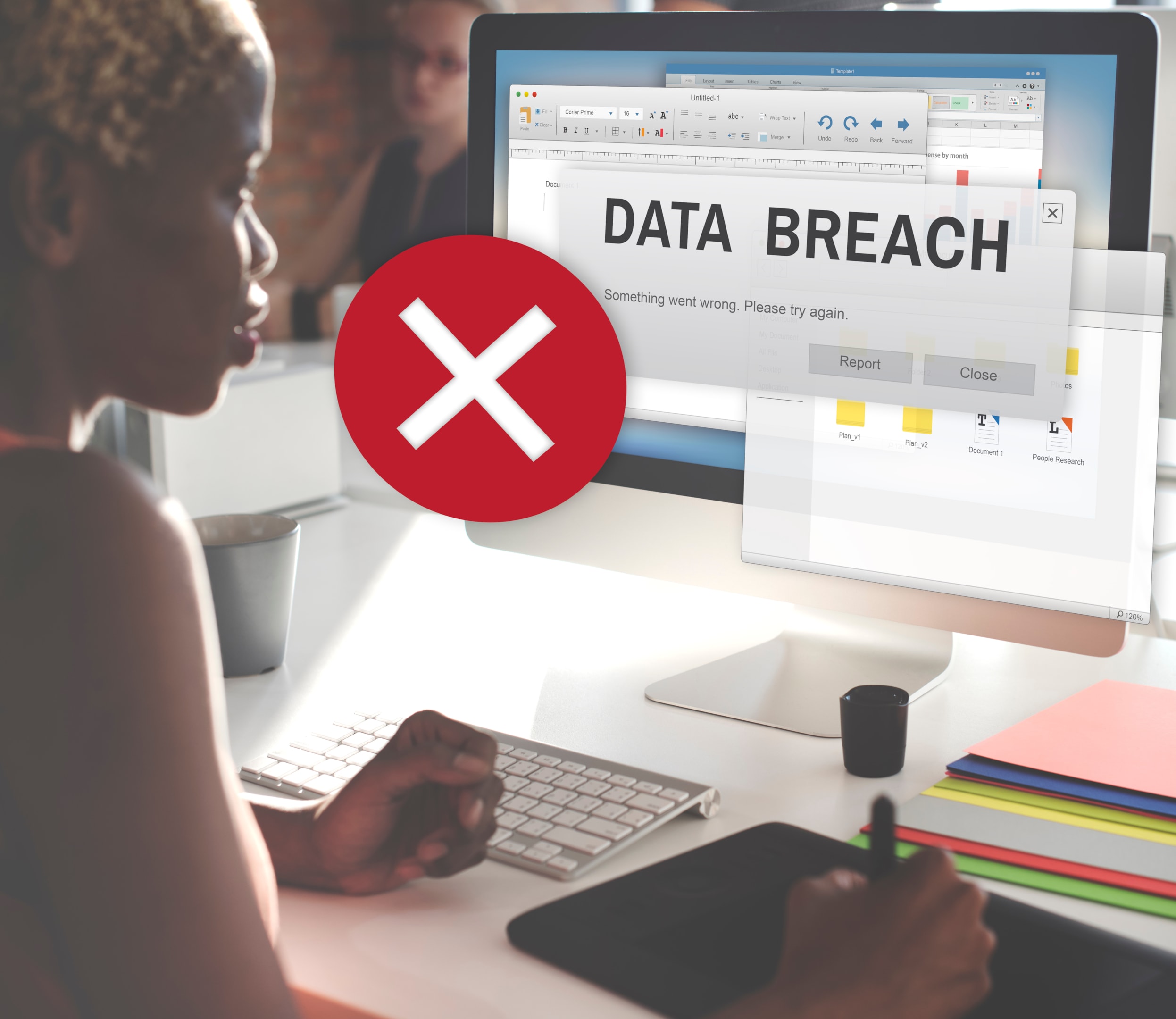 A woman sitting in front of a computer suffers an employer data breach.