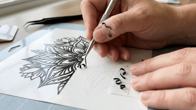 A man is weeding extracting unwanted vinyl from the remaining little pieces.