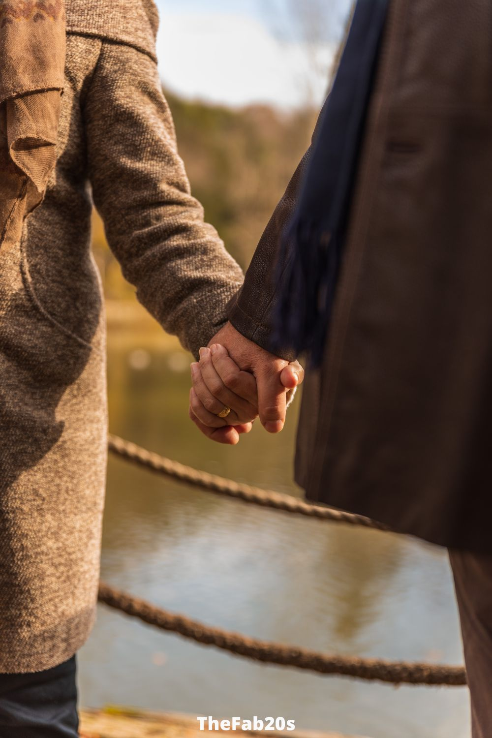 Couple Holding Hands, lake behind them - Featured in Signs An Older Man Is Falling In Love With You
