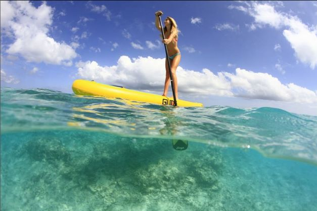 paddling an inflatable stand up paddle board