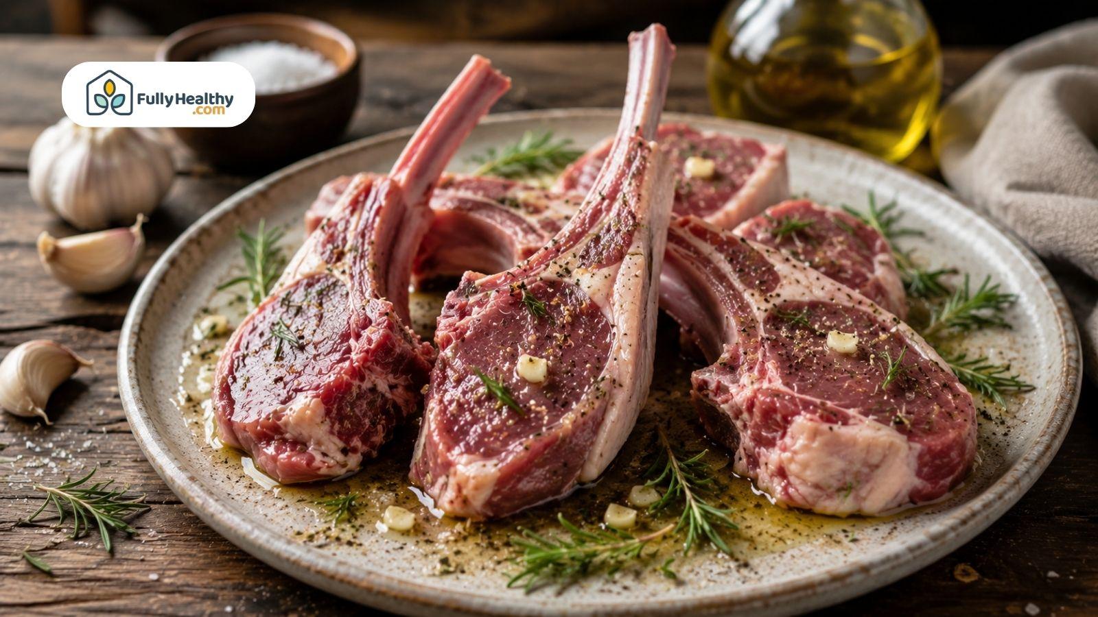 Raw lamb chops seasoned with rosemary, garlic, olive oil, sea salt, and black pepper on a rustic plate over a wooden table.