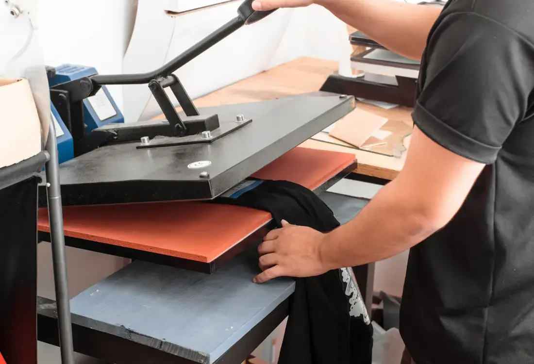 Different printing methods work for different projects. In this picture, there is a press machine, such as DTG printing, for printing shirts.