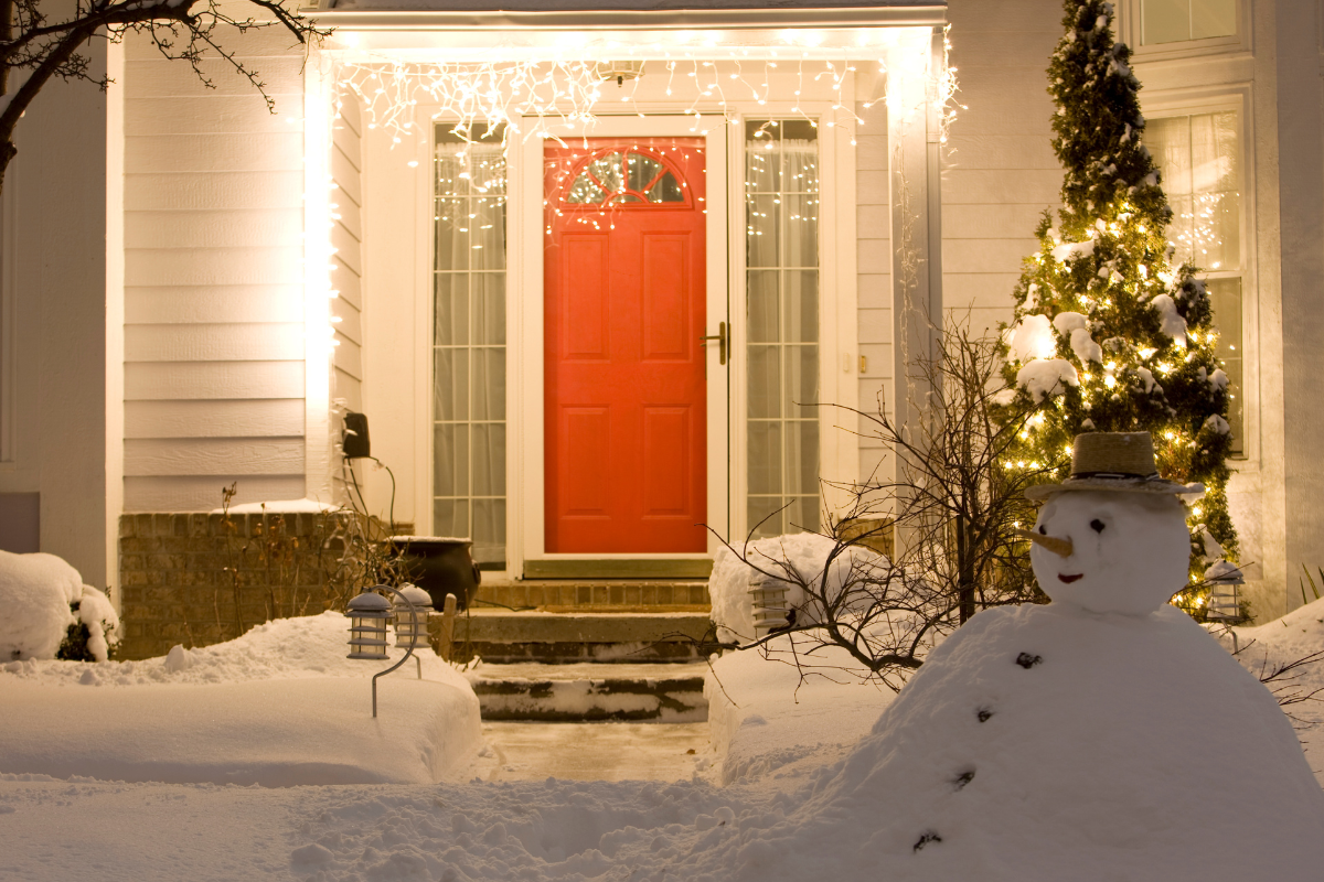 Snowy porch decorations with festive elements and winter scenery.