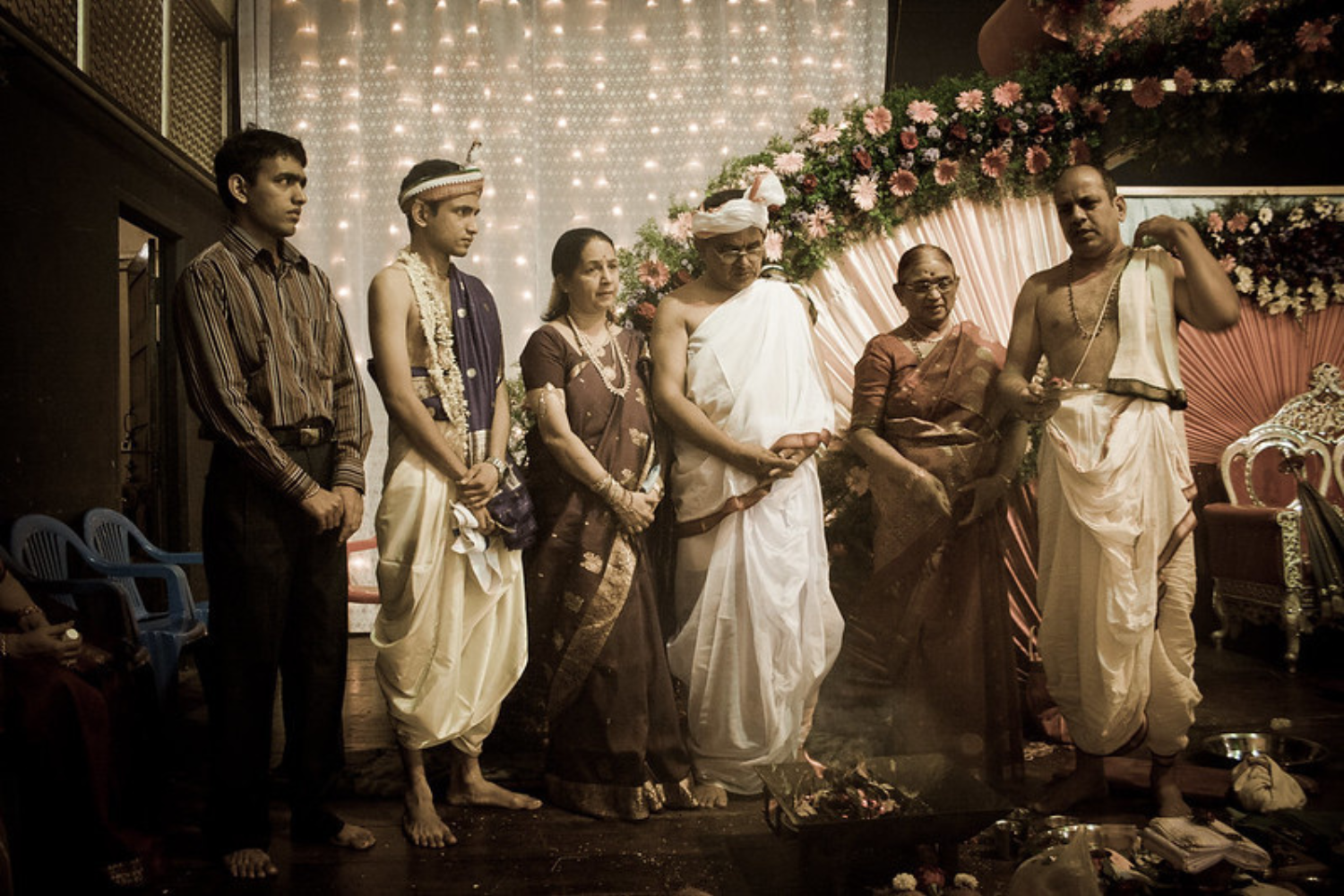 men wearing karnataka traditional dress, dhoti and panche and women wearing silk saree, a man wearing shirt and pant