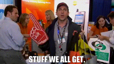 GIF of Michael Scott holding a foam finger and trade show giveaways saying "SWAG: Stuff We All Get" emphasizing how swag attracts prospective customers.