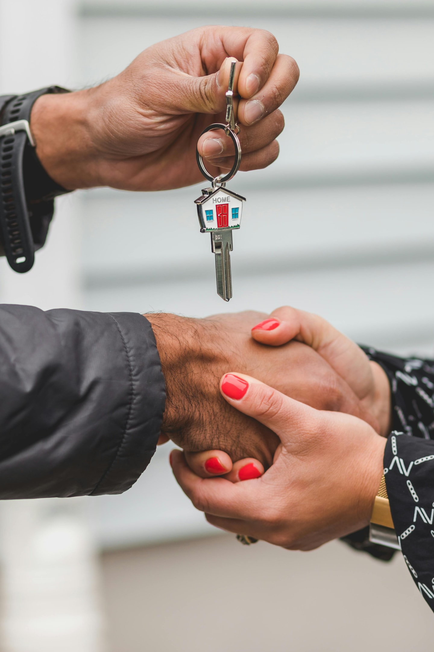 Keys being passed to property purchased by real estate investor. 