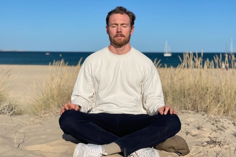 Person practicing meditation in the morning