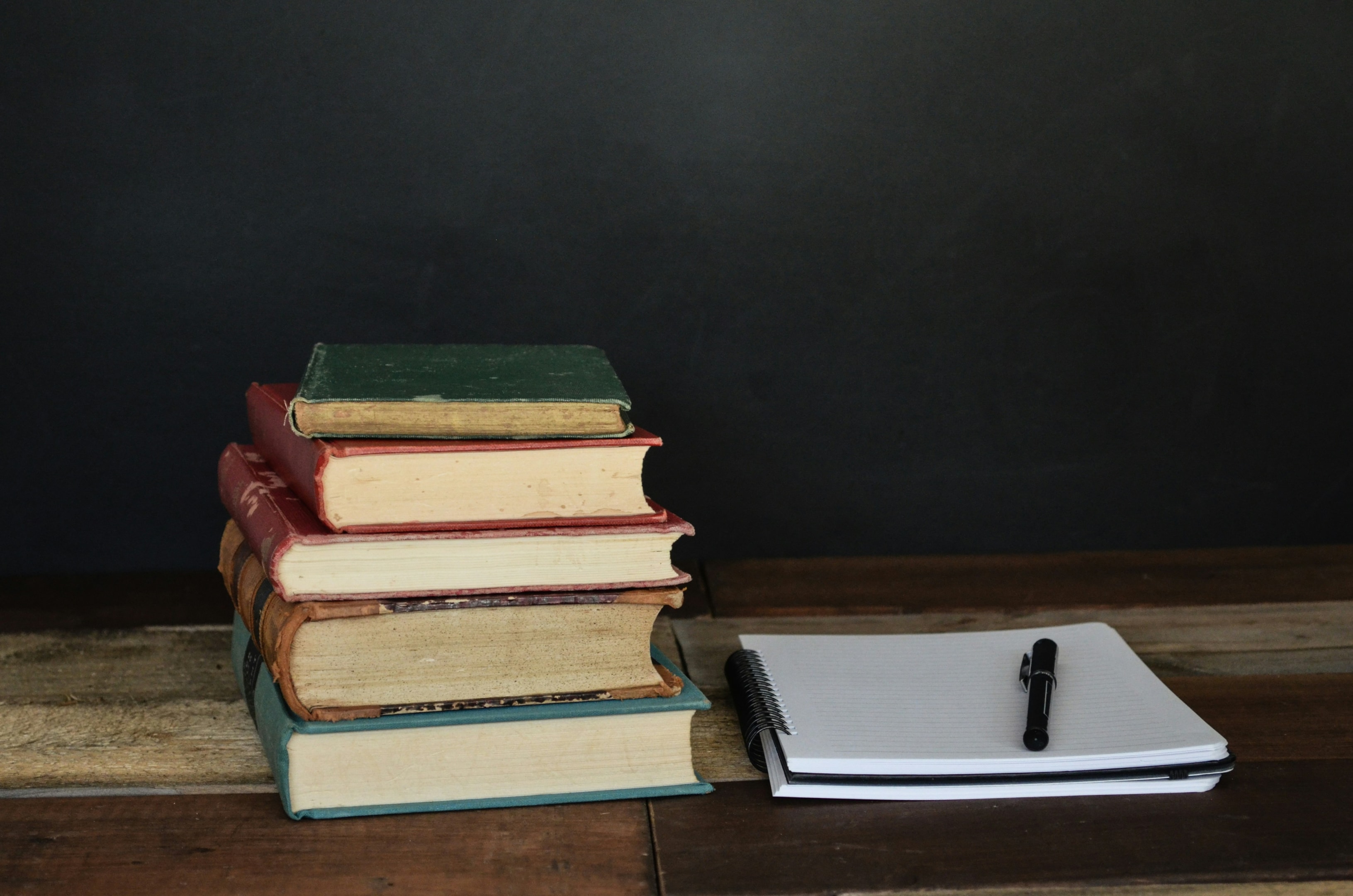 A stack of old poetry books and a notebook.