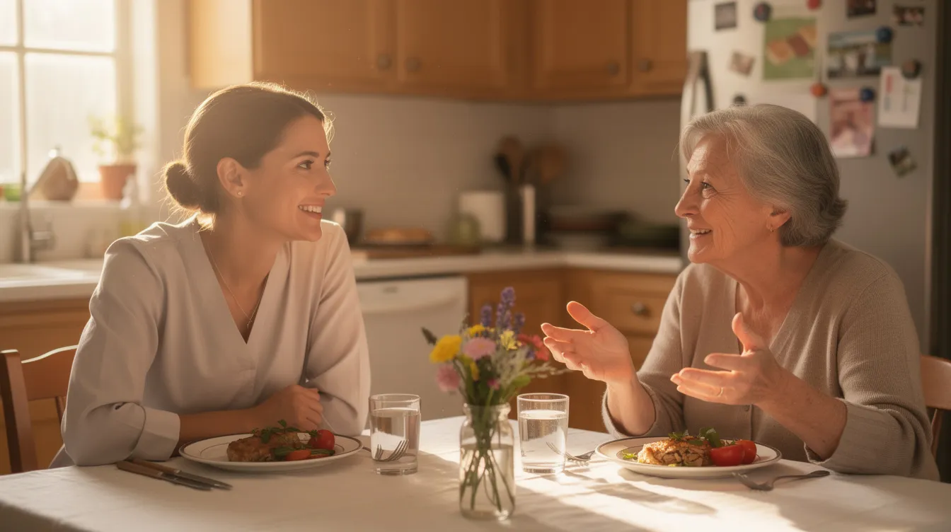 A caregiver and an older adult are seated at a kitchen table, enjoying a meal and engaging in conversation, highlighting the importance of companionship in maintaining overall well-being. This image reflects a nurturing home environment that can help mitigate safety concerns for older adults, emphasizing the value of family caregivers in supporting independent living.