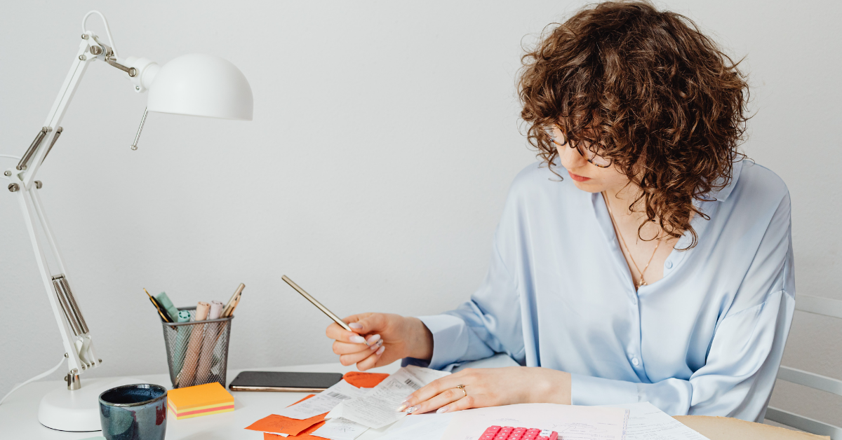 Woman organizing her monthly financial statements to ensure accurate tax reporting.
