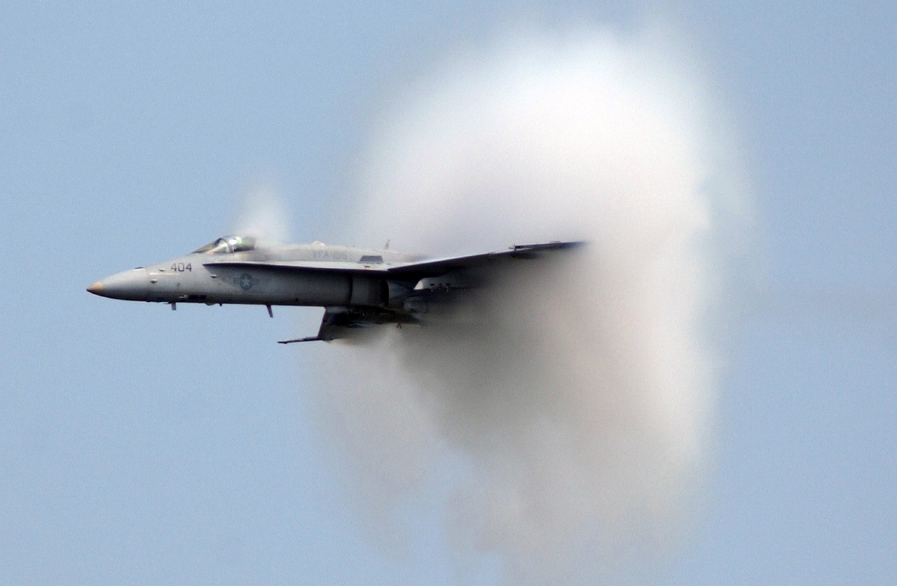 An aircraft creating a sonic boom cloud.