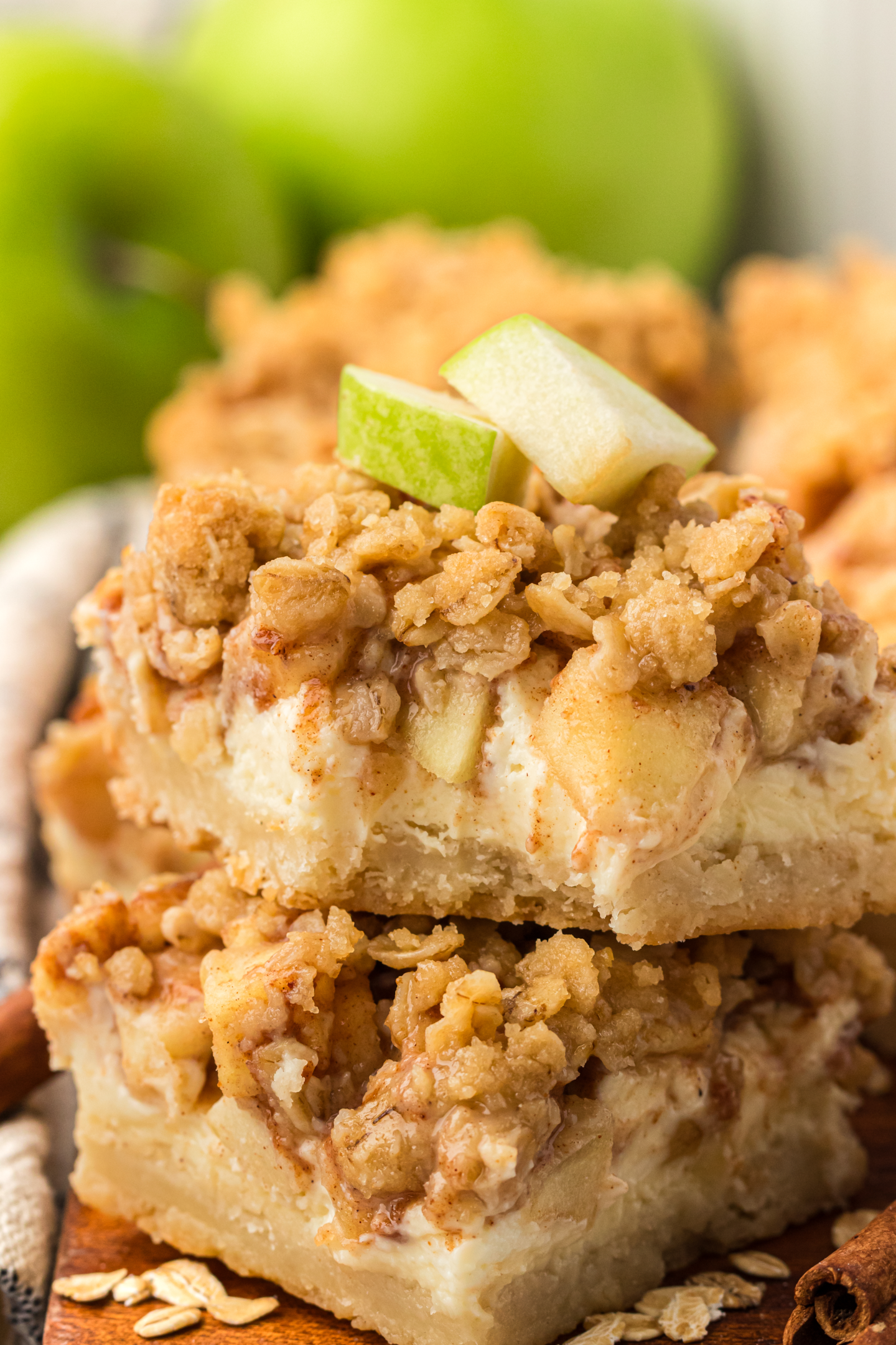 two caramel apple cheesecake bars stacked on top of each other