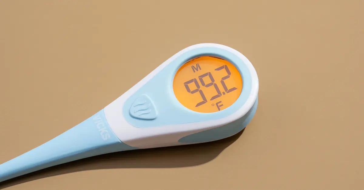 Digital thermometer displaying temperature with fever threshold