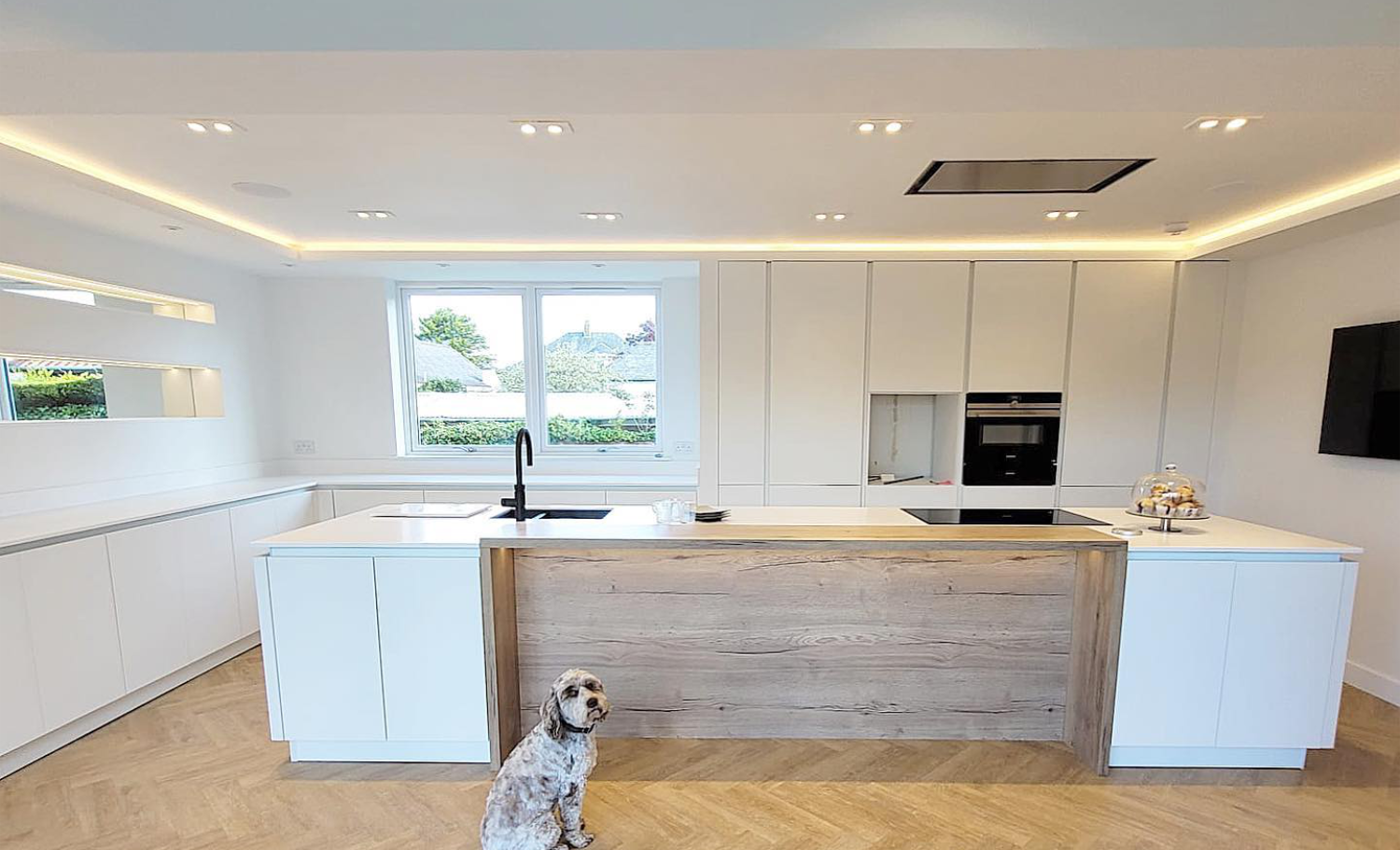 An innovative kitchen storage solution with hidden pantries, built-in banquettes and open shelving