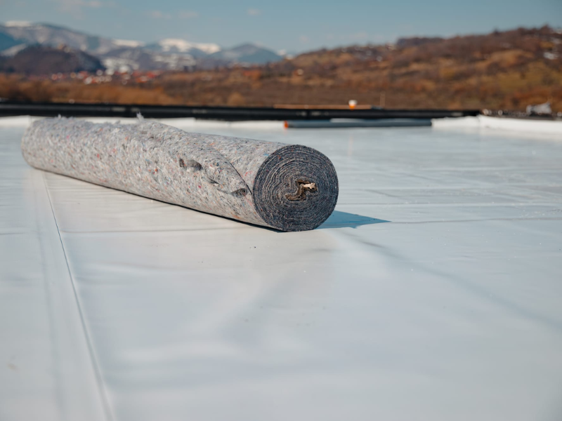 An image showing commercial roof coating material on a business building. 