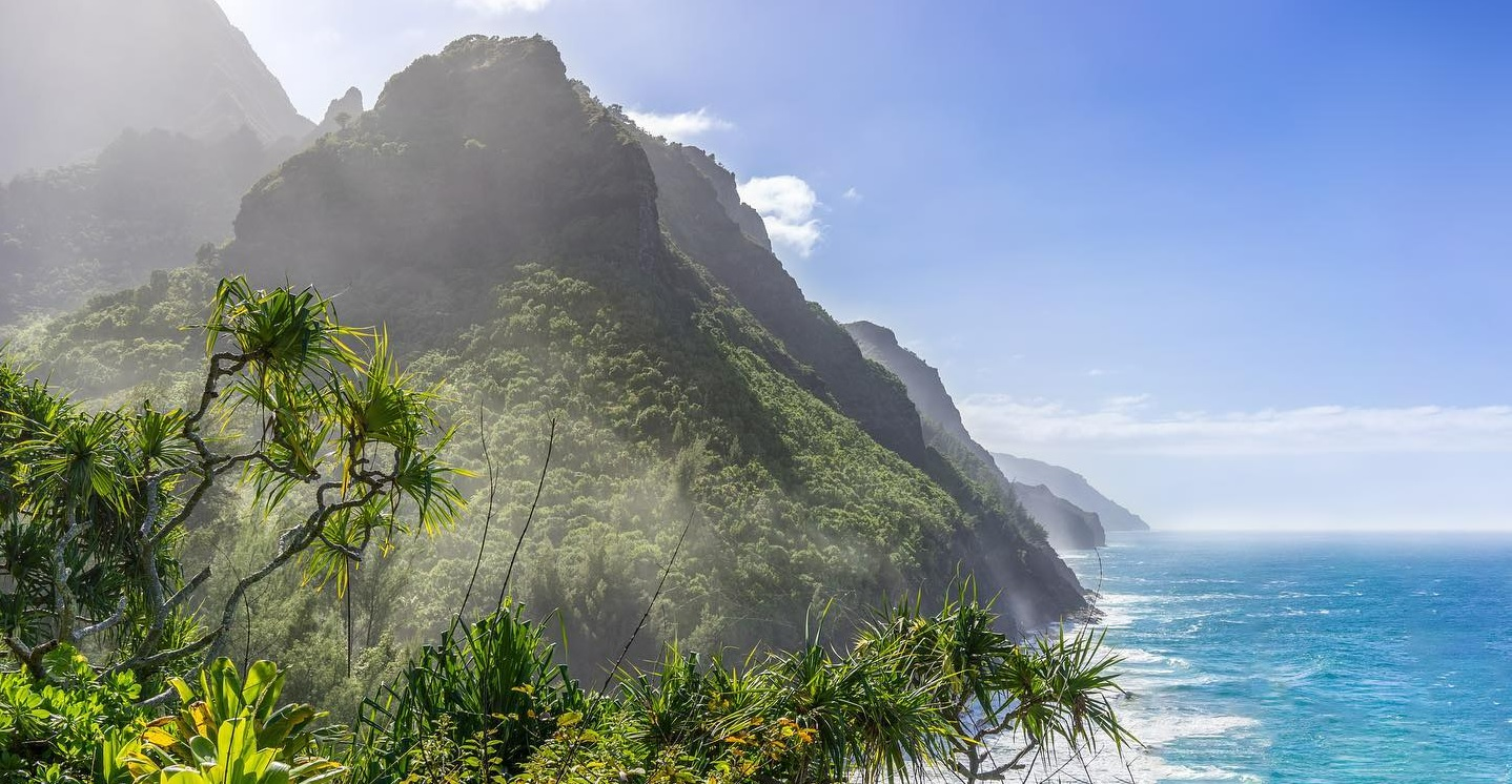 Hawaiian coastline with steep mountains and tropical plants