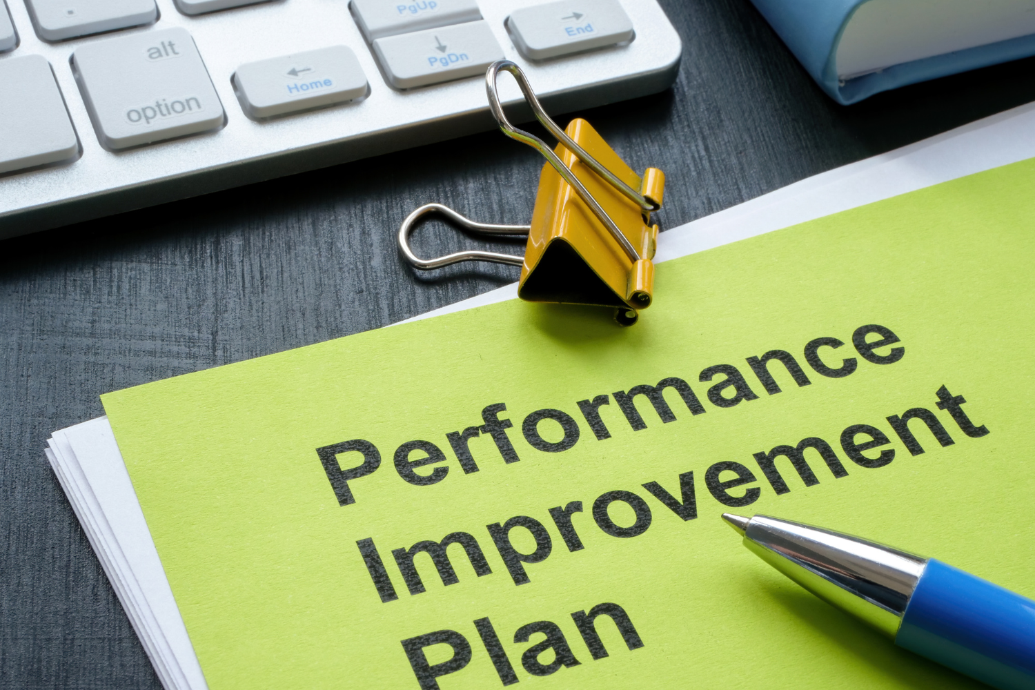 A folder with Performance Improvement Plan written on a folder.