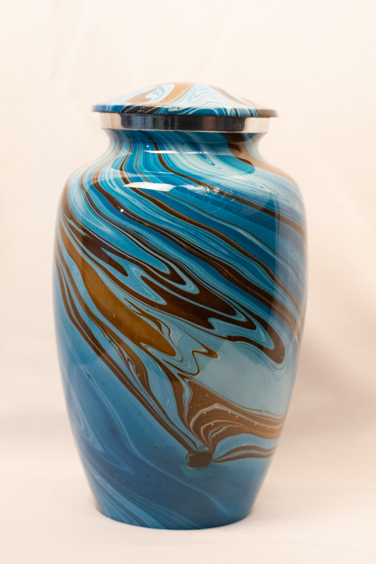 A ocean blue color aluminum large adult urn by Reverie Memorials