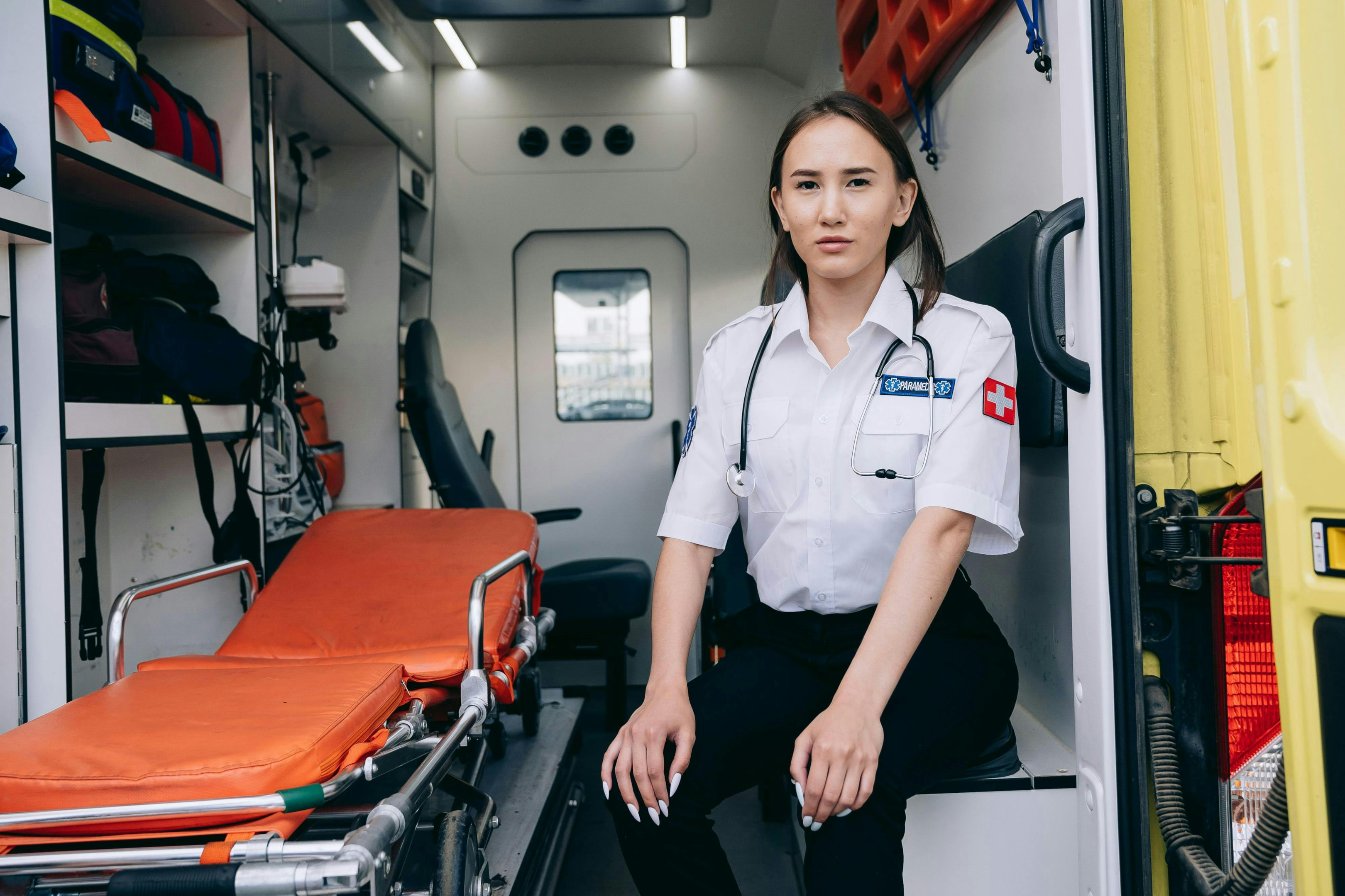 A paramedic sitting with a foldable stretcher. 