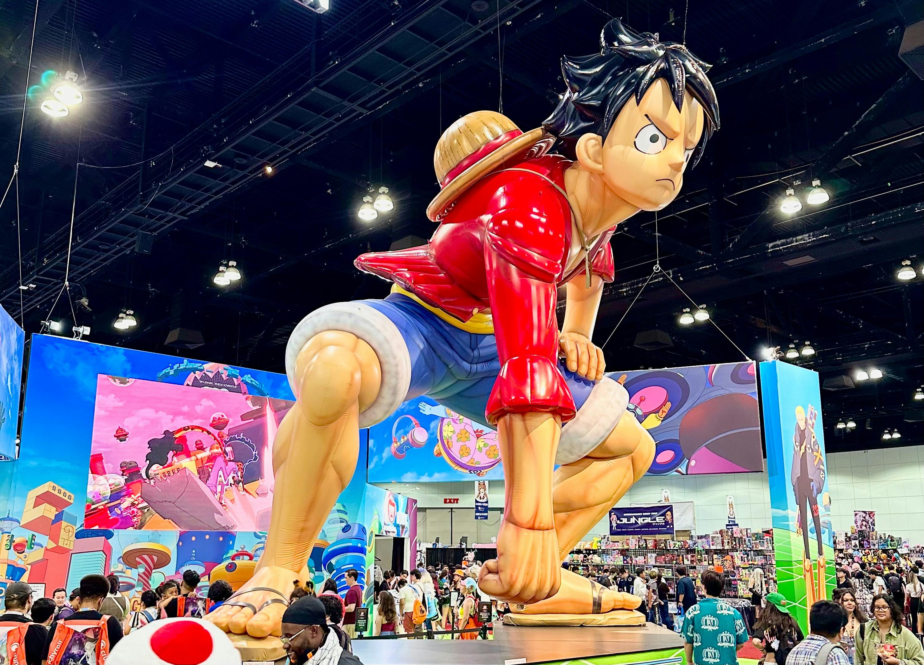 A giant inflatable of Monkey D. Luffy at a convention.