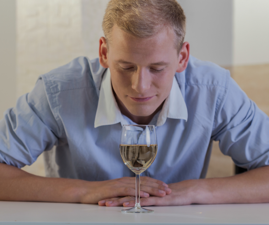 An image showing a person struggling to resist alcohol with the text 'Why is it so hard to stay sober?' written in bold letters.