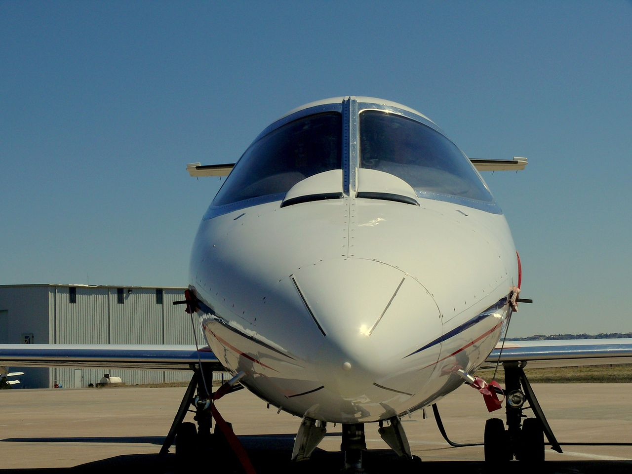 The nose and cockpit windshields of a Learjet 25.