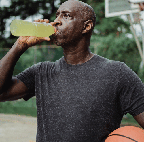 A person drinking electrolyte powder to enhance athletic performance