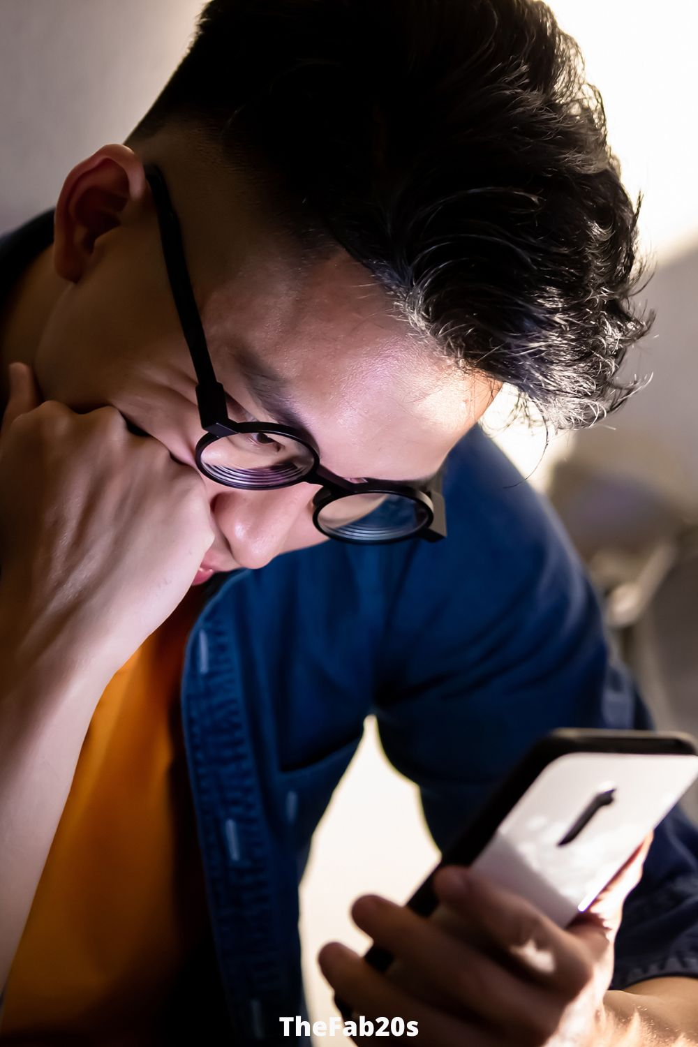 Man checking phone, looking upset