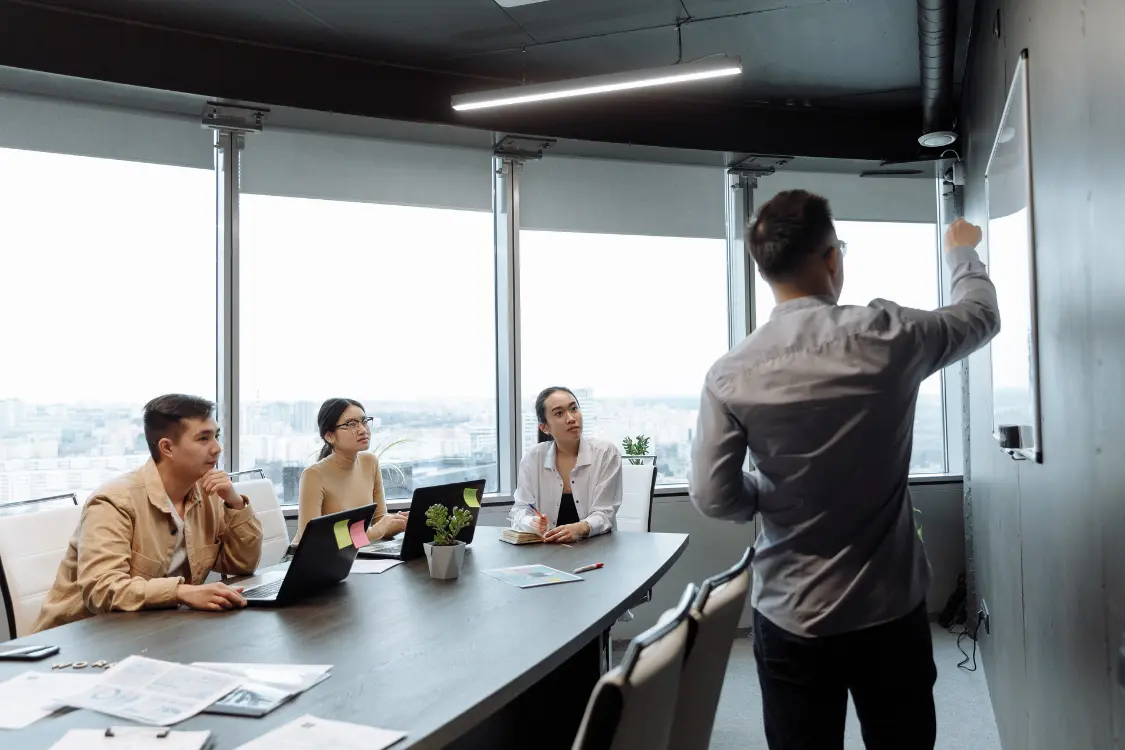 Business broker presenting prequalified buyer profiles during a strategic sales discussion