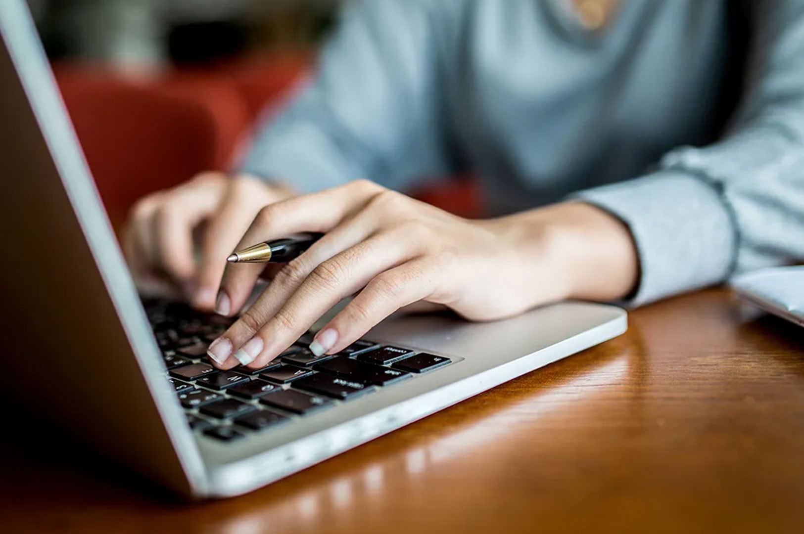 Person researching maid agencies on a laptop.