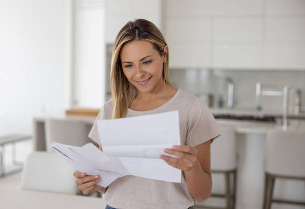 Happy woman checking insurance documents