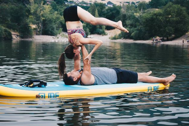 sup yoga on an inflatable paddle board