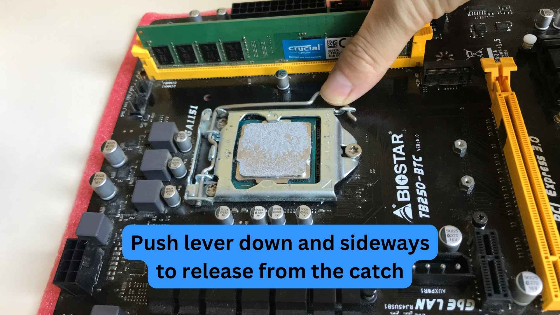 Push lever down and sideways to release from the catch