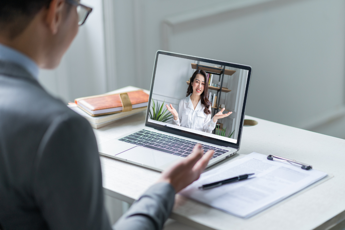 A person conducting a virtual assistant interview via video call, highlighting the remote hiring process for virtual team members.