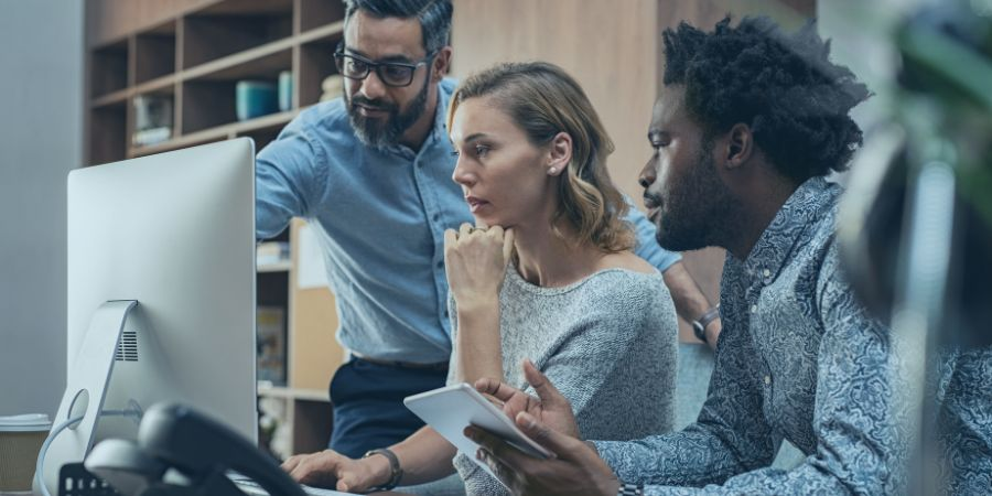 Crisis management team members looking at computer