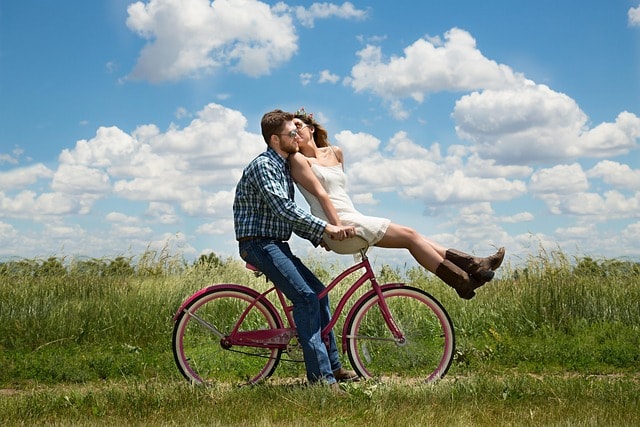 partner visa australia checklist, eligible New Zealand citizen, partner visa, happy valentines day, couple, romance, bike, bicycle, meadow, field, happy, romantic, kiss, affection, together, lovers, man, woman, relationship, young couple, love, outdoors, portrait