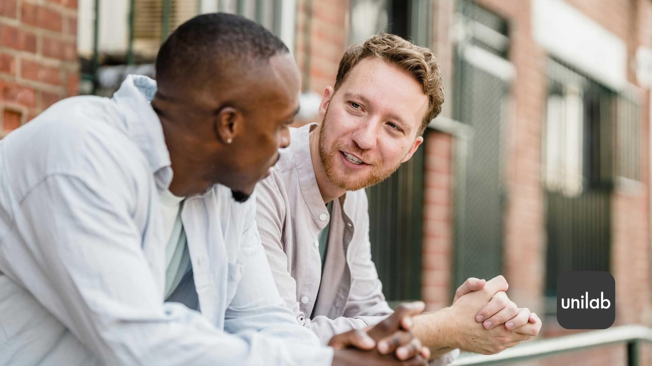 Two men talking to each other outside of a building