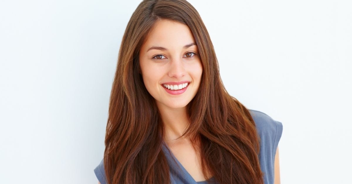 Smiling woman with long hair, symbolizing confident business owners filing the 1094 Tax Form.