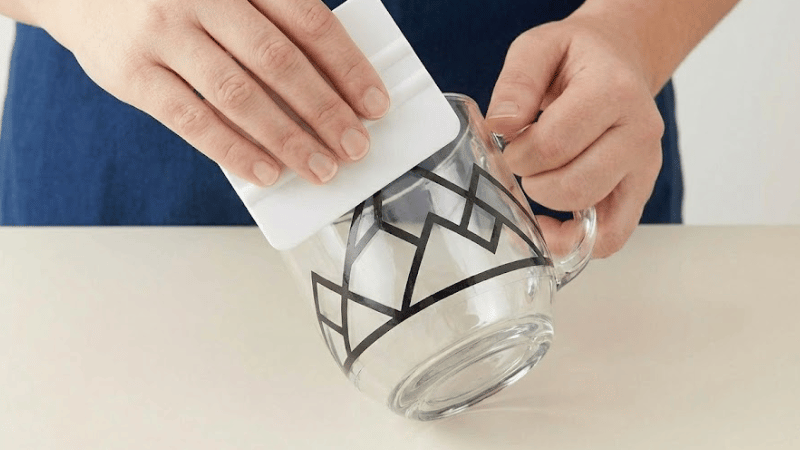 A man is burnishing once more to ensure full adhesion.