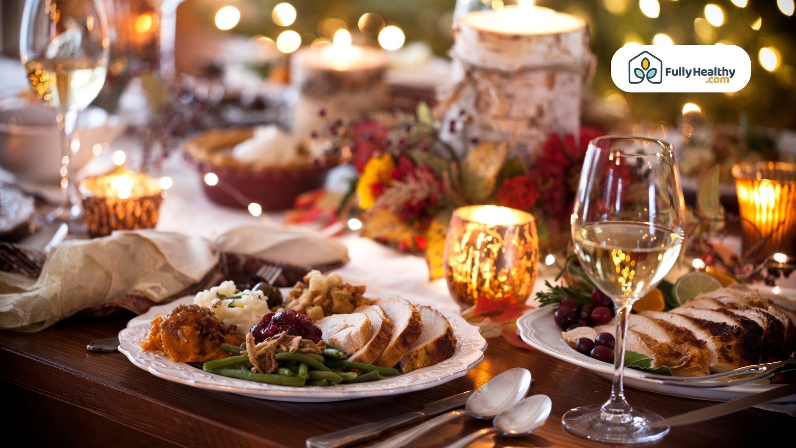 Thanksgiving dinner table with turkey slices vegetables candles and wine glasses