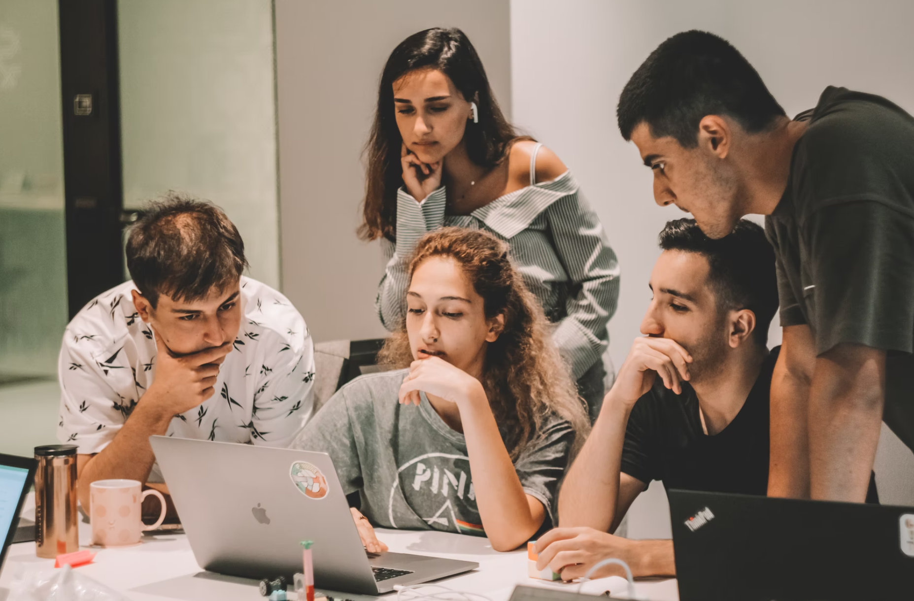 Group of people looking at a computer