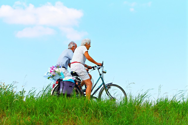senior couple on bikes in a field showing a healthy lifestyle