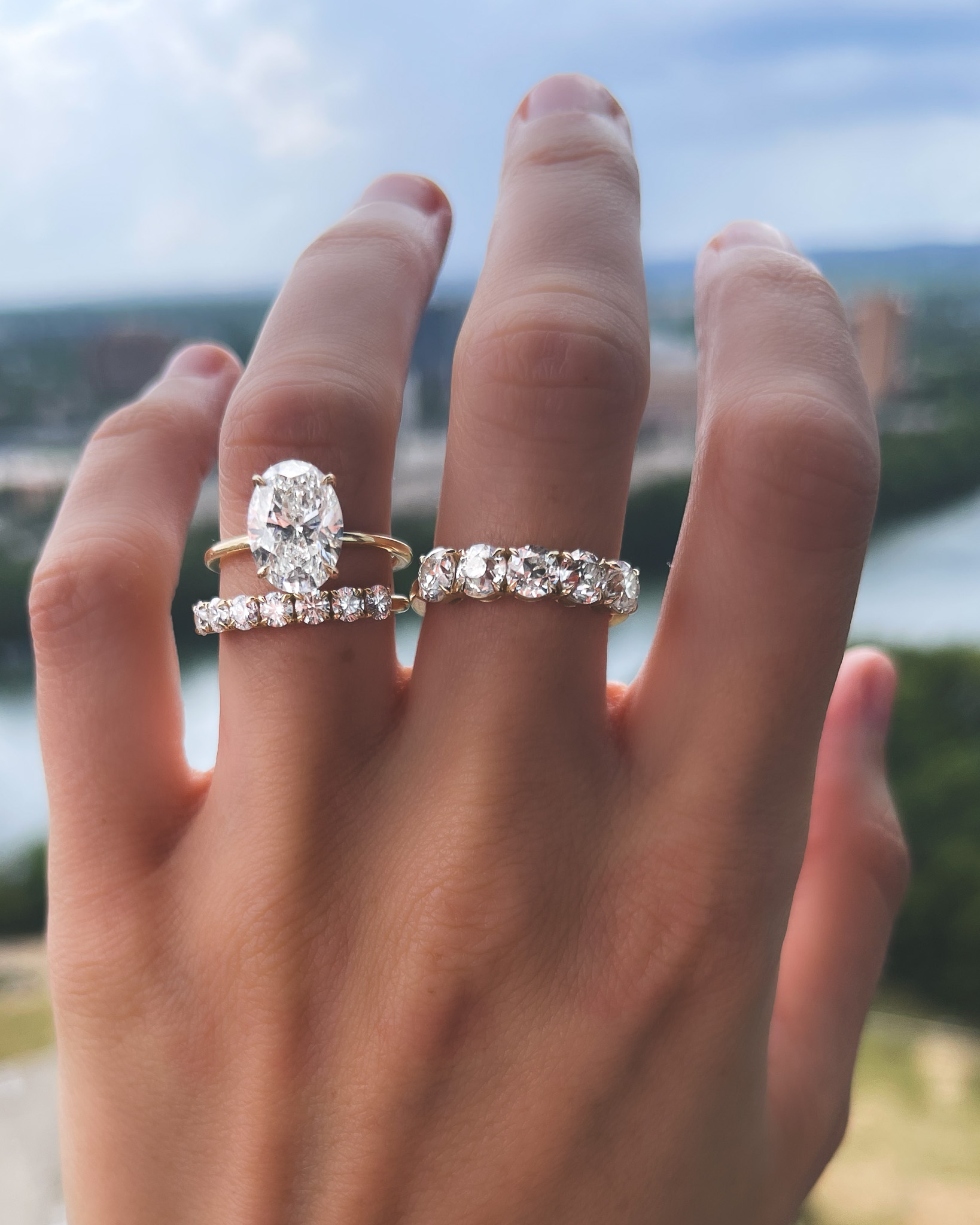 A stunning image showcasing the perfect pairing of an oval engagement ring with wedding band. The wedding band perfectly complements the oval shape of the engagement ring, creating a beautiful and cohesive look.