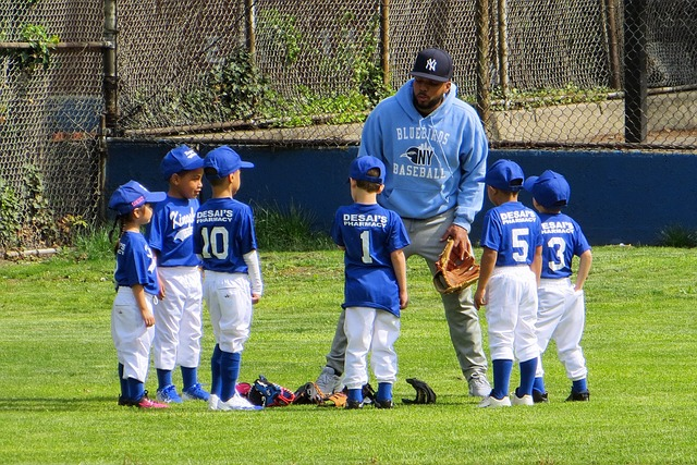 An image of a coach demonstrating how to coach tee ball players during a fun game to enhance their skills.