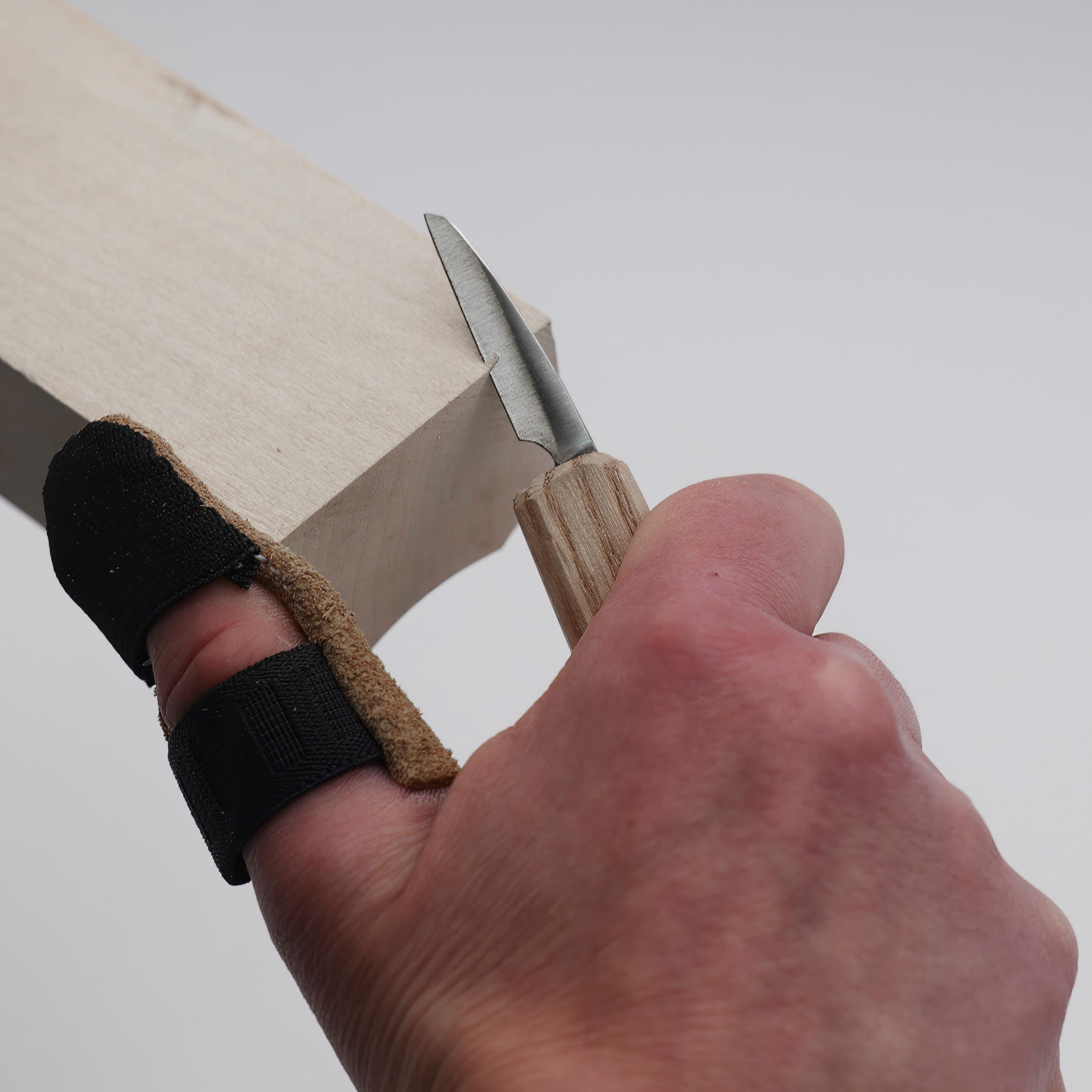 A thumb guard on the knife hand.