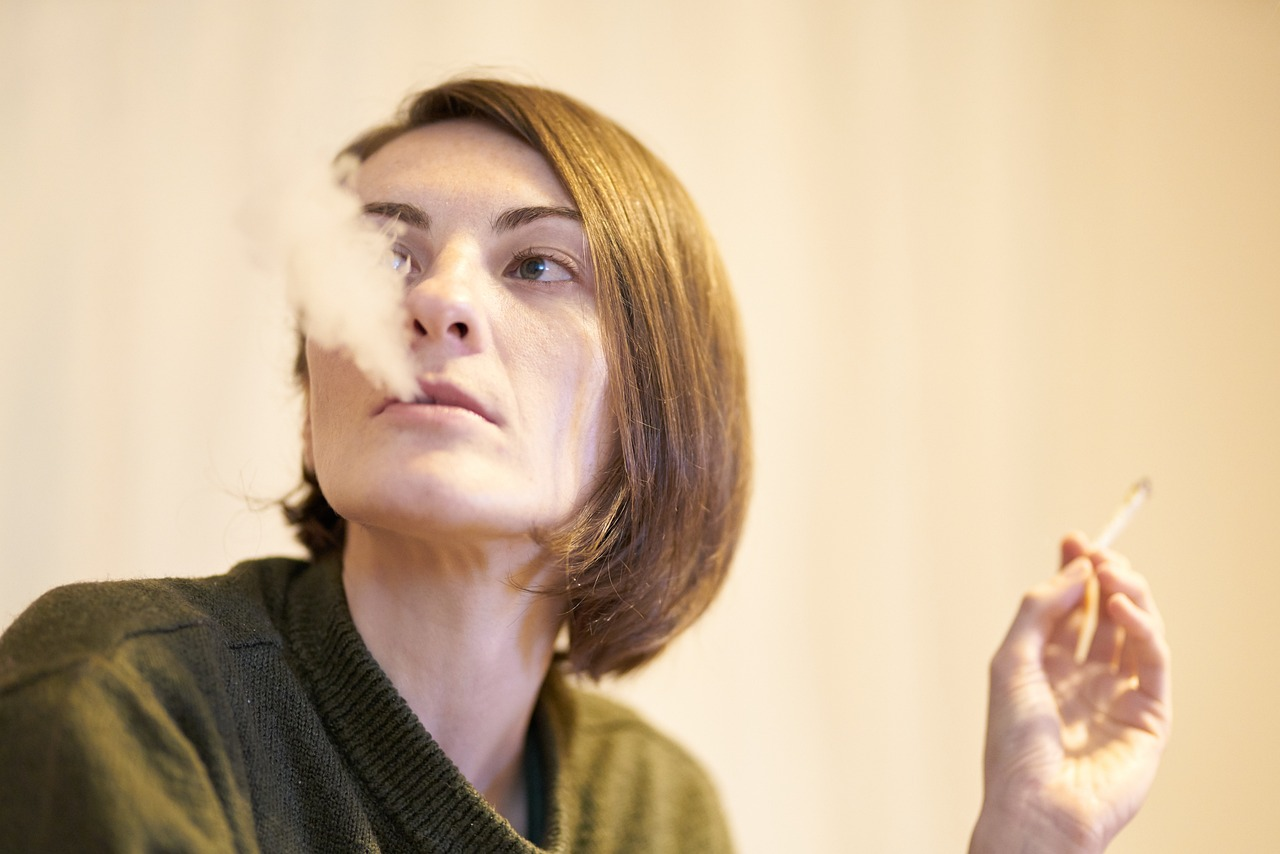 An image of a woman smoking a cigarette. 