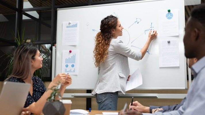 A person developing a marketing strategy with a laptop