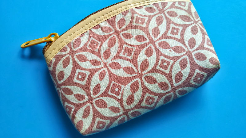 A small coin purse with a batik pattern on it